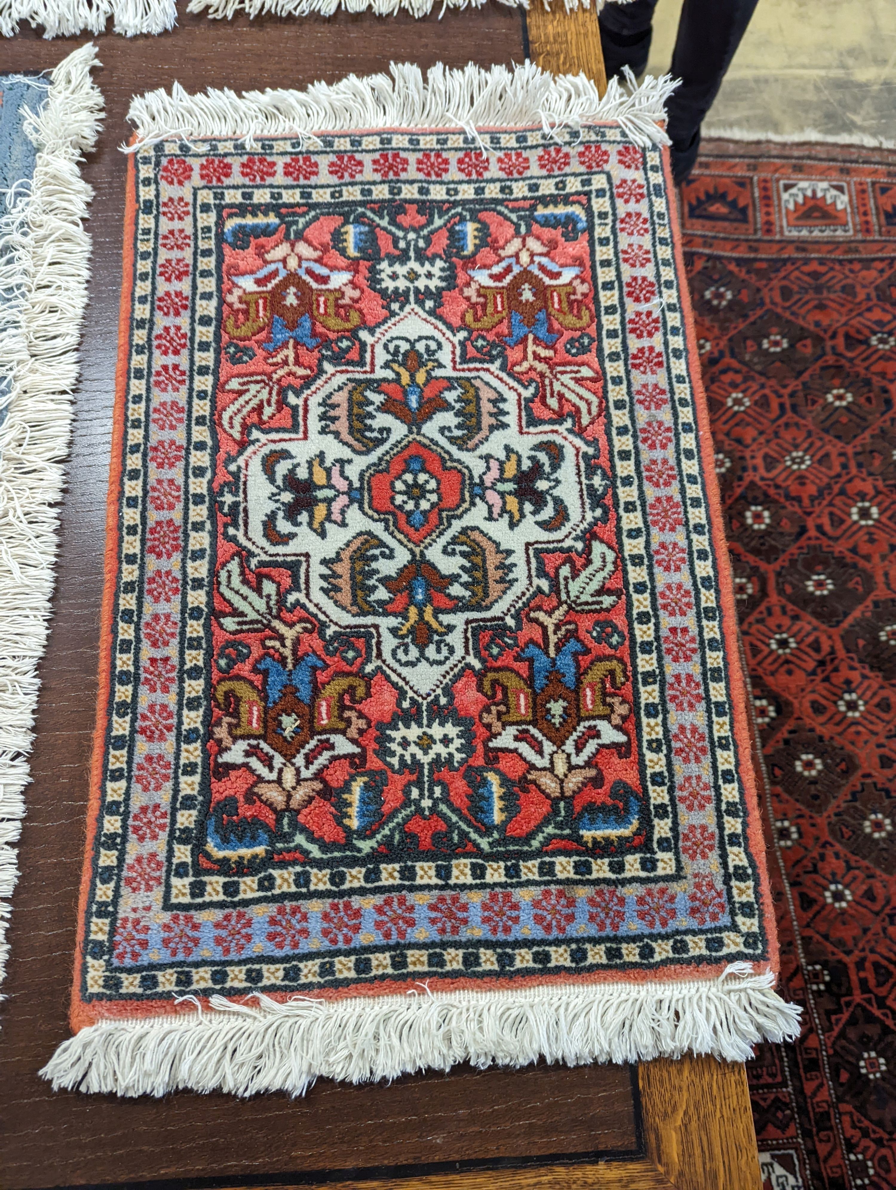 A Caucasian red ground mat, a Bokhara mat, three others and a blue ground rug, largest 136 x 80cm (6)